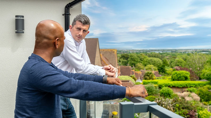Ashley talking with client overlooking Eastbourne